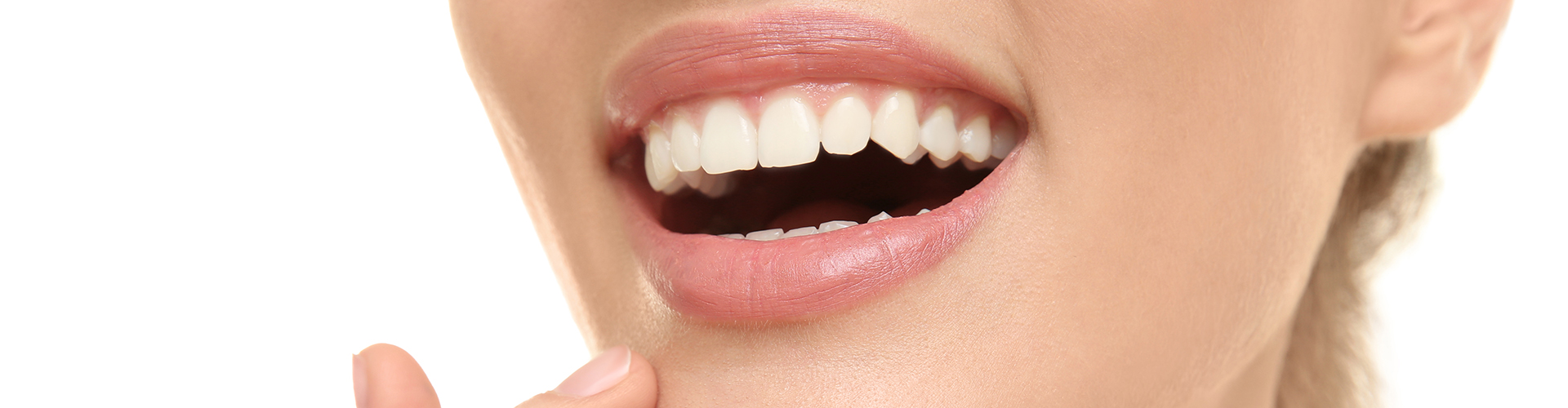 Woman smiling and touching her chin.