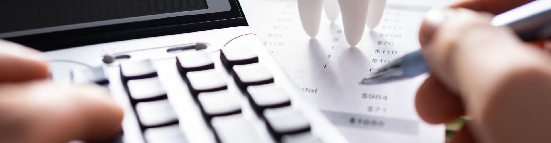 giant tooth beside a calculator