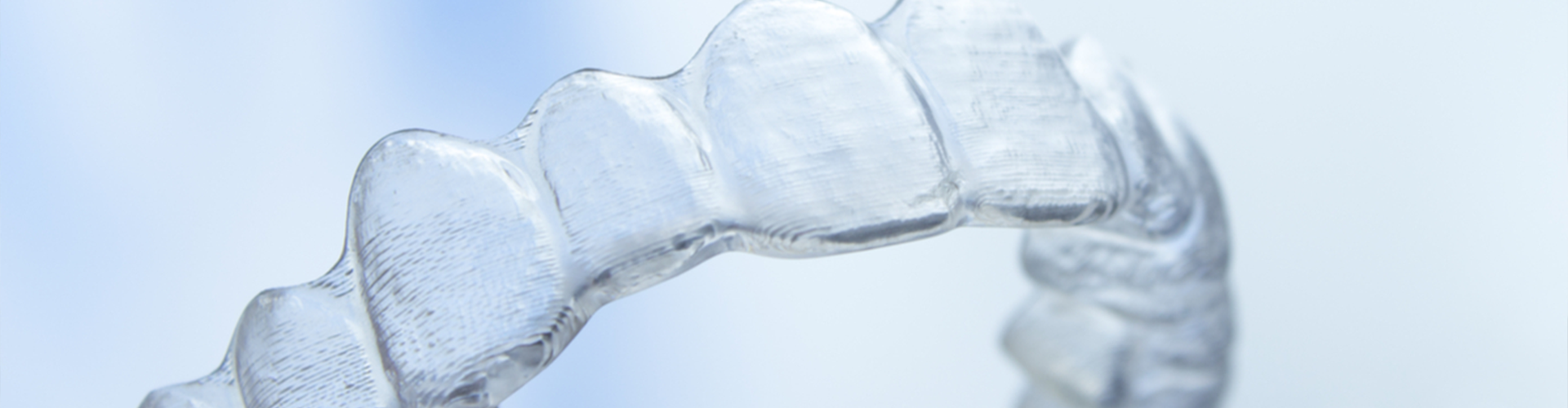 girl with braces smiling in front of dental staff
