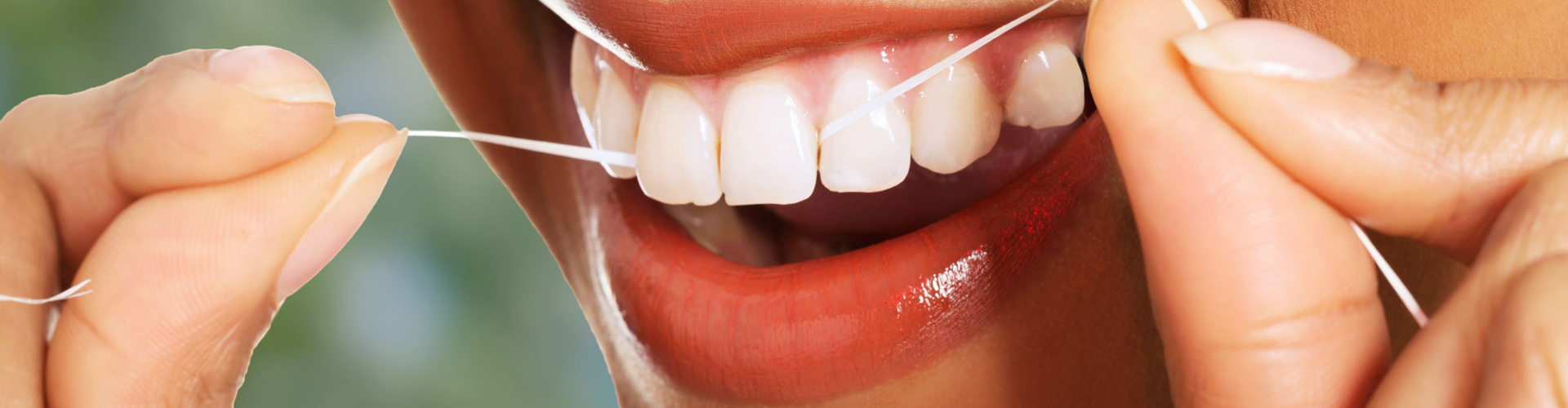 Woman flossing teeth.