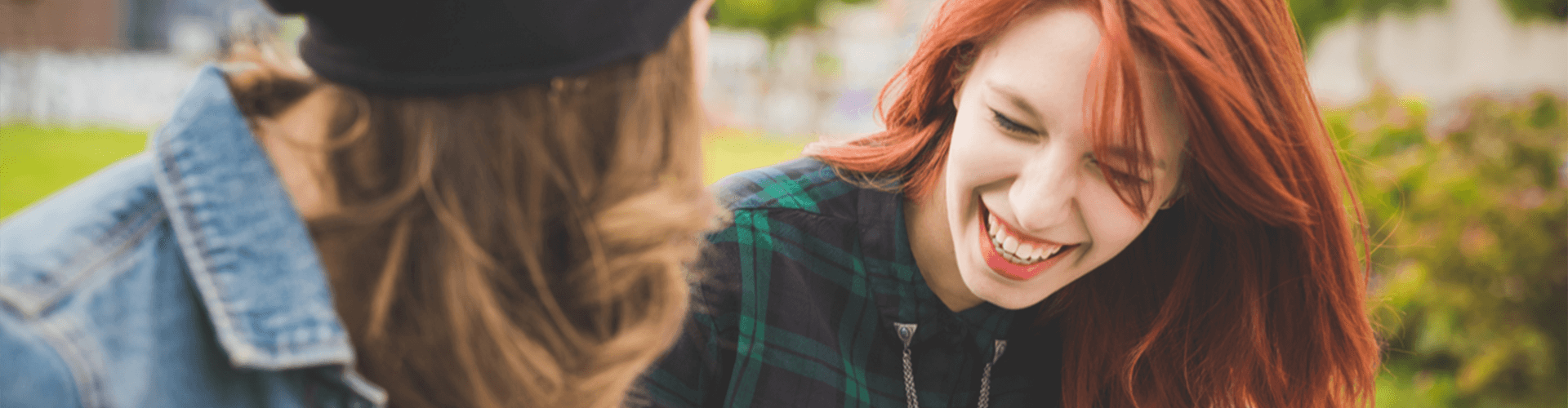 Woman looking at her laughing friend.