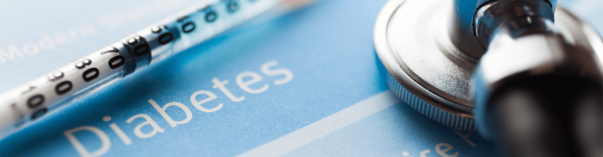 Syringe beside a stethoscope.