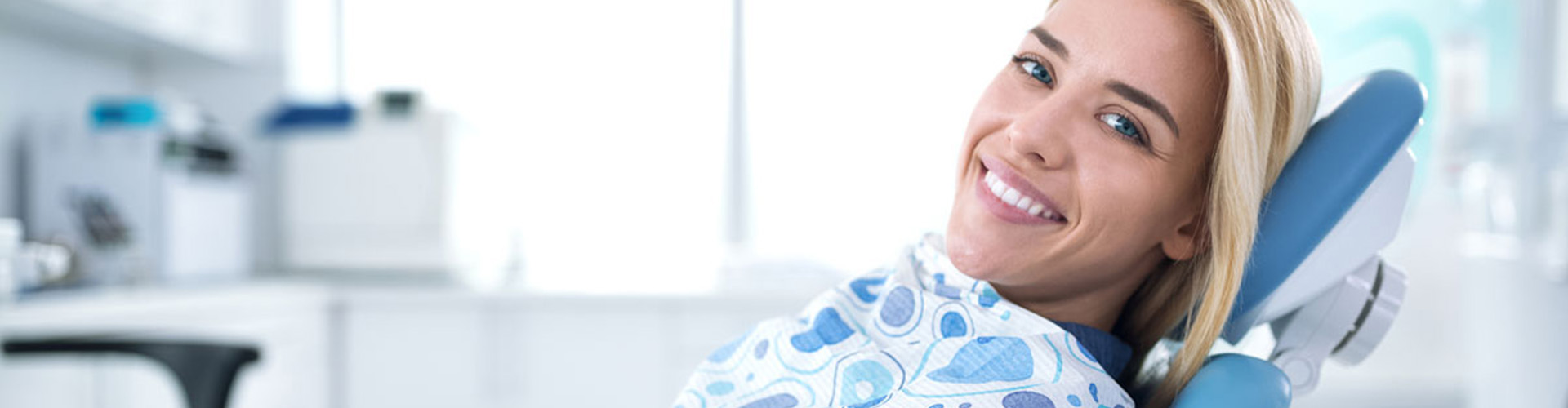 Female smiling in dental office chair.