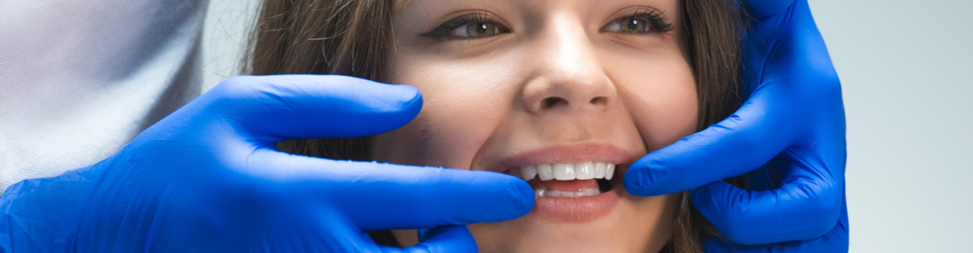 female having teeth checked by dentist