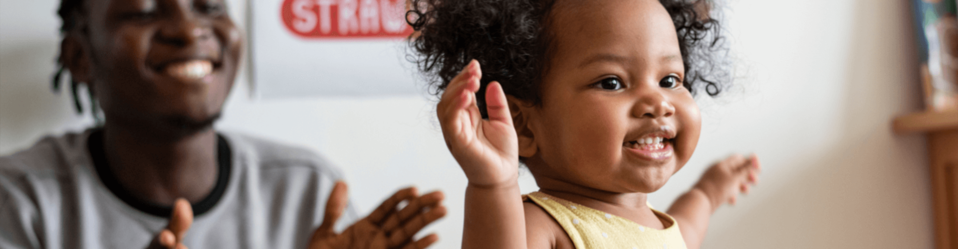 Female child toddling with male adult.