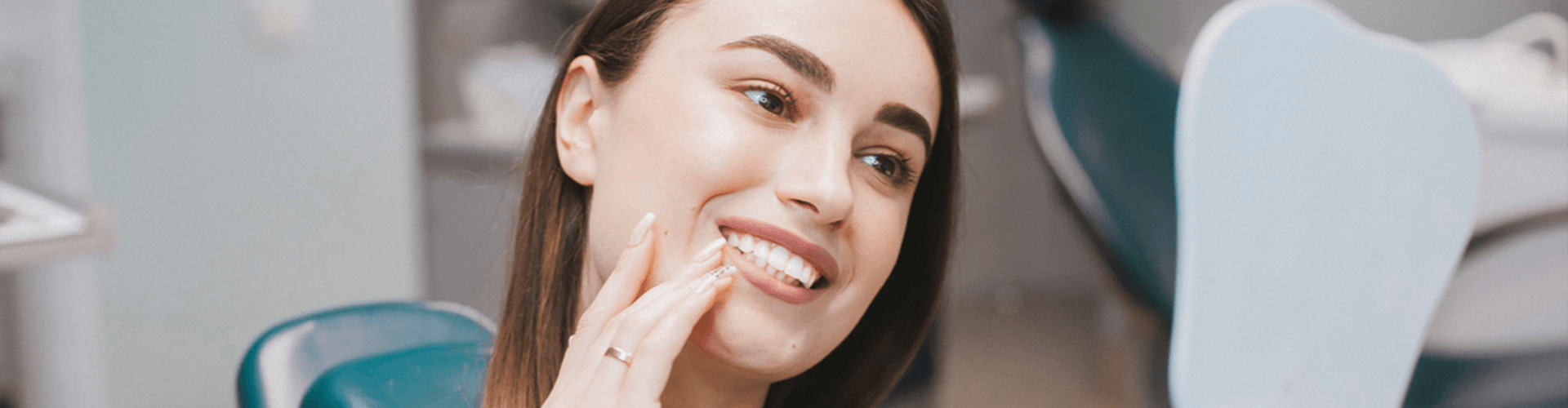 Female smiling with mirror.