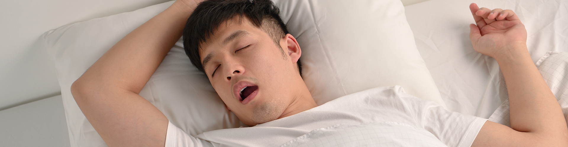 man sleeping on his back with his mouth open