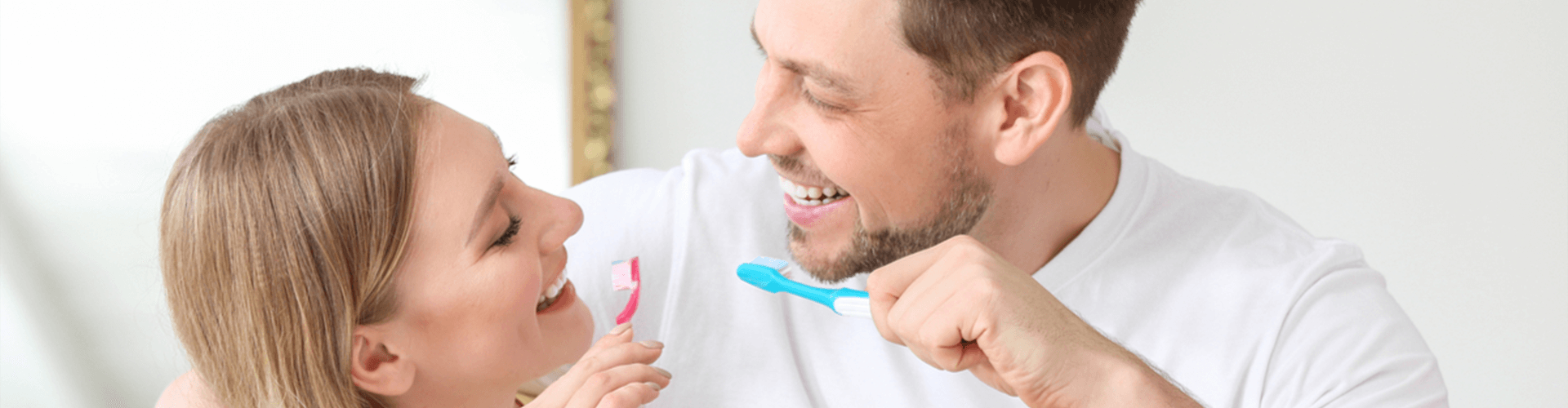 Couple brushing teeth.