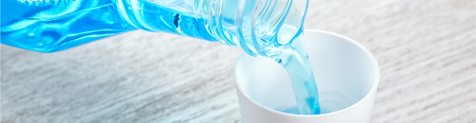 Mouthwash being poured into a cup.