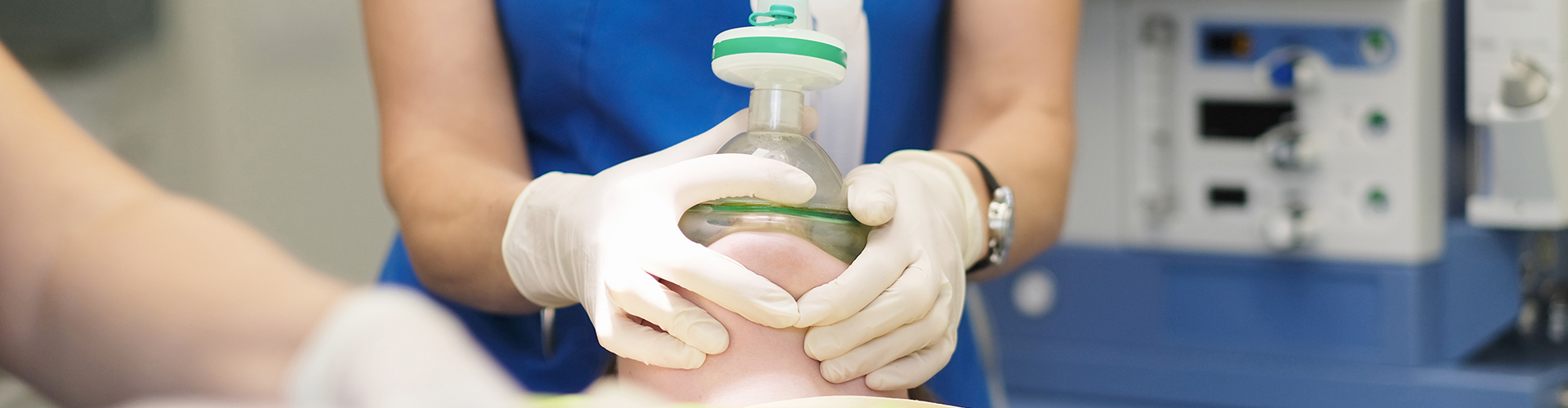dental professional holding breathing mask over person's face