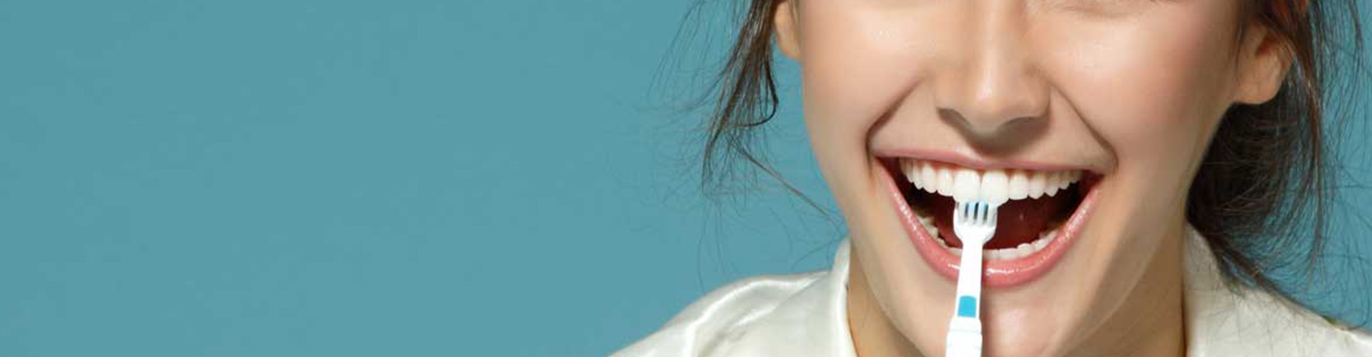 Female with toothbrush in mouth.